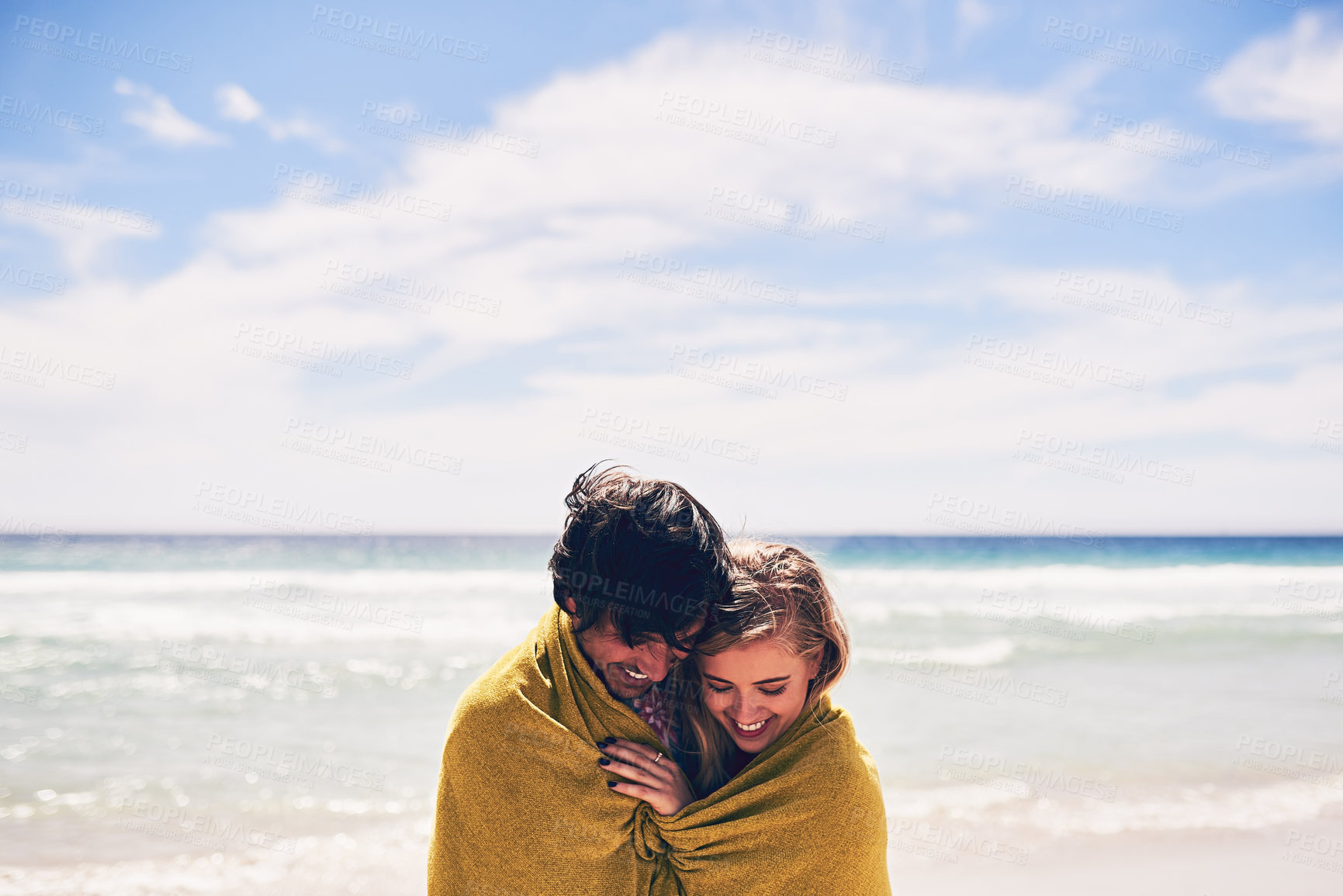 Buy stock photo Couple, towel and ocean for swim and vacation, beach and cold water plunge in sea. Happy, love and married people on holiday for honeymoon adventure, travel and waves or blue sky together with smile