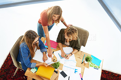 Buy stock photo High angle shot of two female university students working on a project together at a table on campus
