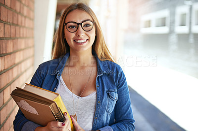 Buy stock photo Portrait of a smiling female university student  standing on campus carrying books