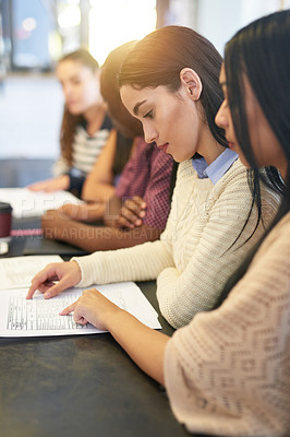 Buy stock photo Students, notes and women at table for studying, research and session in cafeteria. Study group, papers and survey for learning together in college for education, progress and knowledge for exams