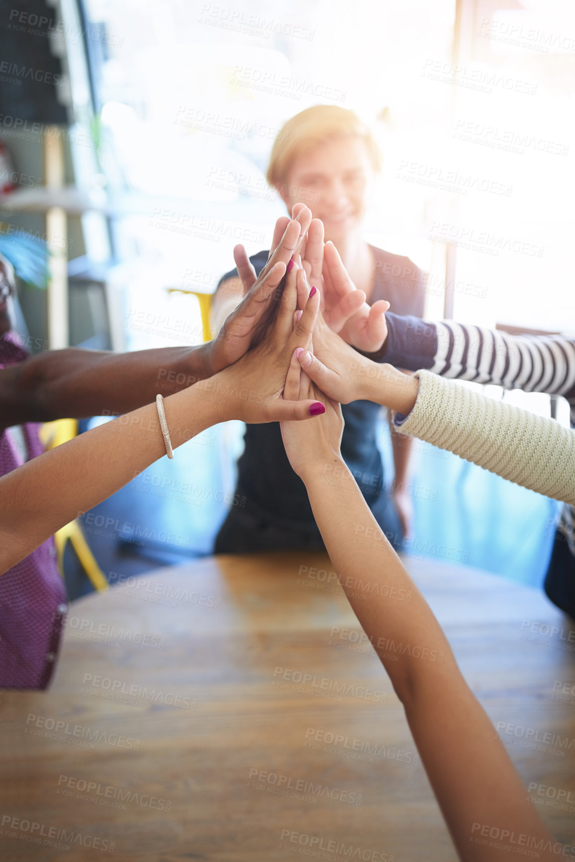 Buy stock photo Teamwork, high five and business people on table in office for collaboration, community and agreement. Startup company, diversity and above of men and women for meeting, support and team building