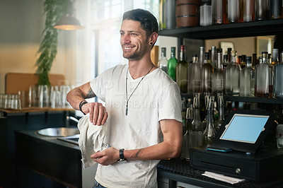 Buy stock photo Waiter, man and cleaning a glass in cafe with smile for daydreaming and wondering with hygiene in small business. Bartender, person and happy in restaurant with polishing, disinfection and bacteria