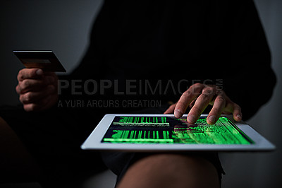 Buy stock photo Cropped shot of an unidentifiable hacker using a tablet late at night