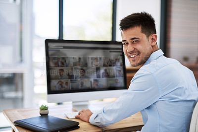 Buy stock photo Portrait of a happy businessman using a computer at his work desk