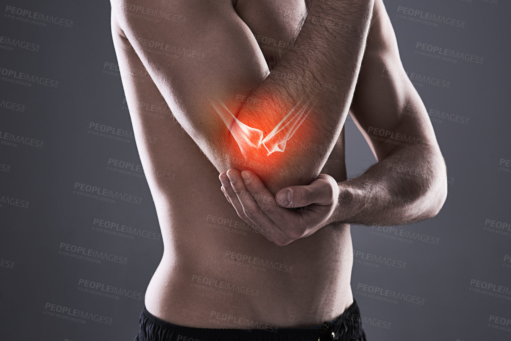 Buy stock photo Cropped shot of a young man in the studio with cgi highlighting his elbow injury