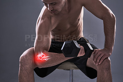 Buy stock photo Cropped shot of a young man in the studio with cgi highlighting his elbow injury