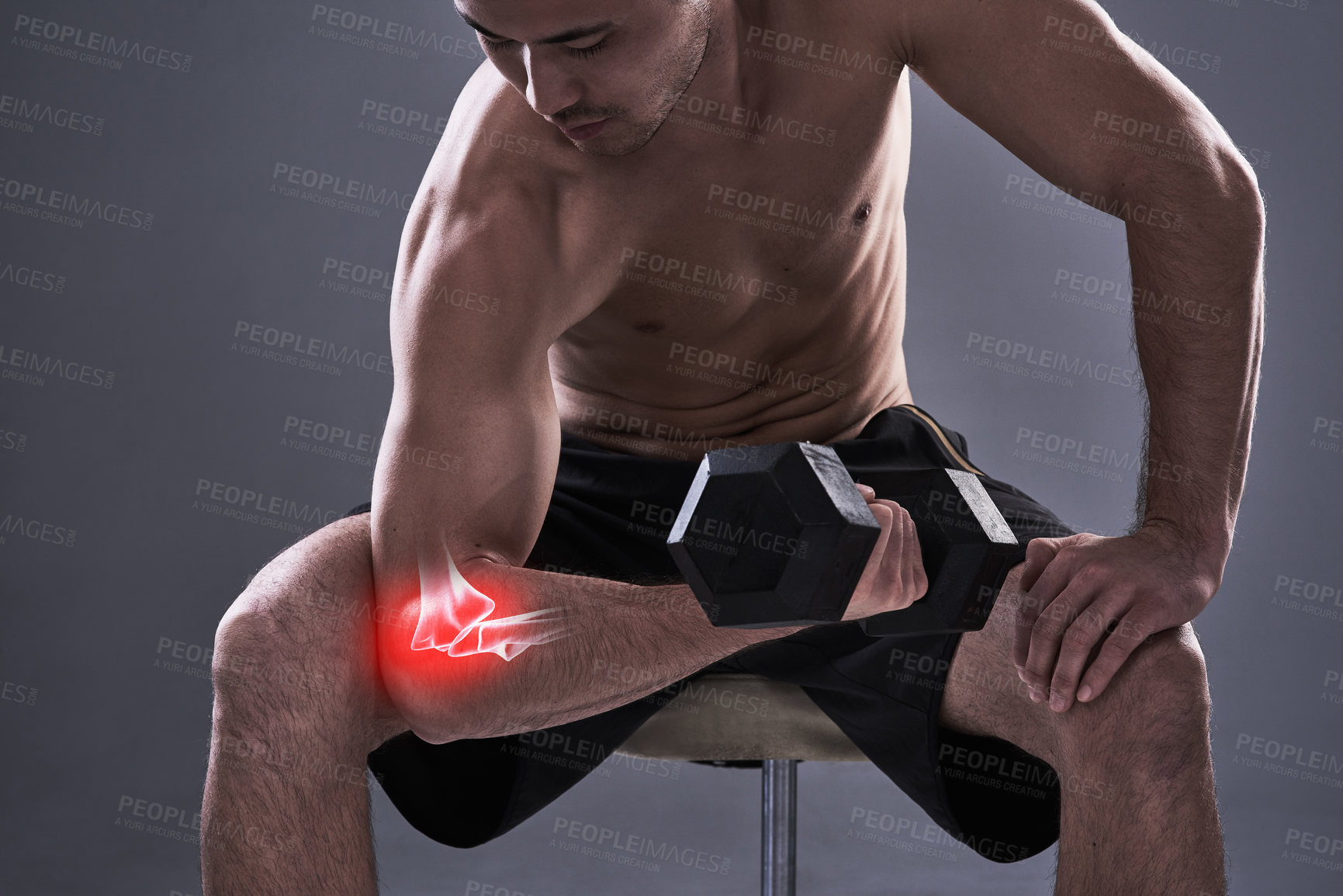 Buy stock photo Cropped shot of a young man in the studio with cgi highlighting his elbow injury