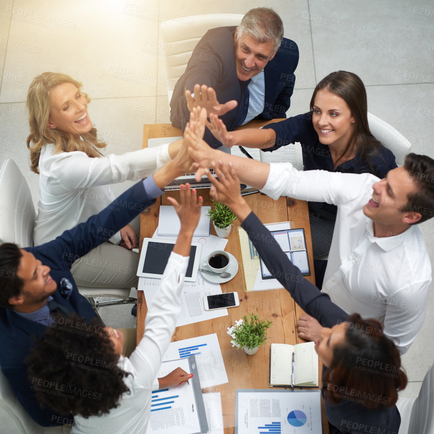 Buy stock photo Business people, high five and teamwork in a meeting with a happy team to celebrate finance success. Above corporate men and women at table with hands, paperwork and infographics for budget or profit