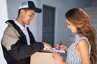 Buy stock photo Cropped shot of a young woman signing for her package from the courier