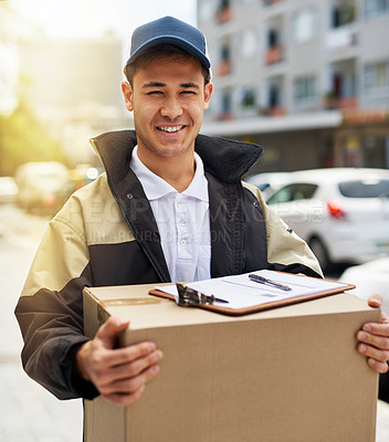 Buy stock photo Portrait of a courier carrying a package during a delivery