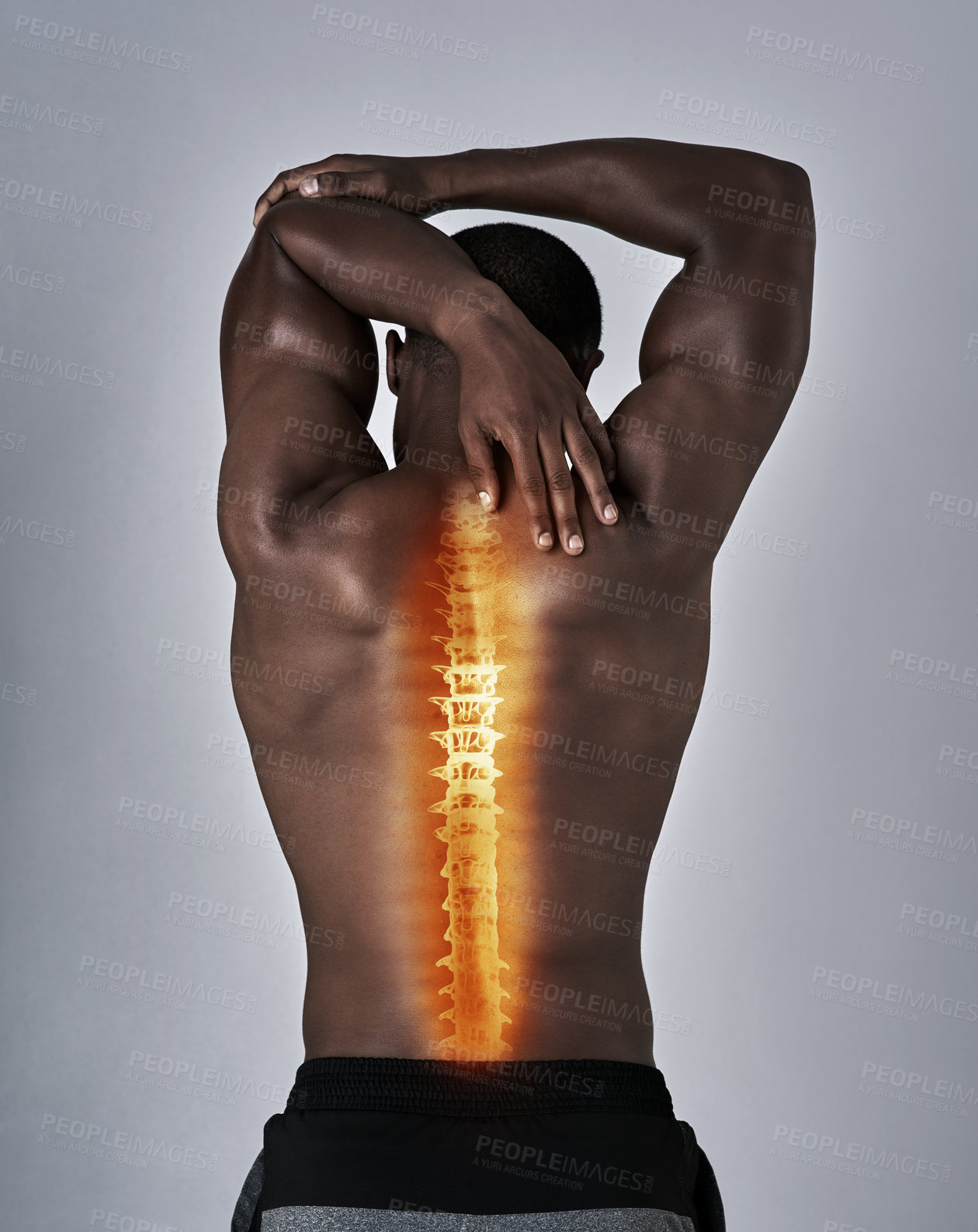 Buy stock photo Rearview shot of an athletic young man warming up with a back injury