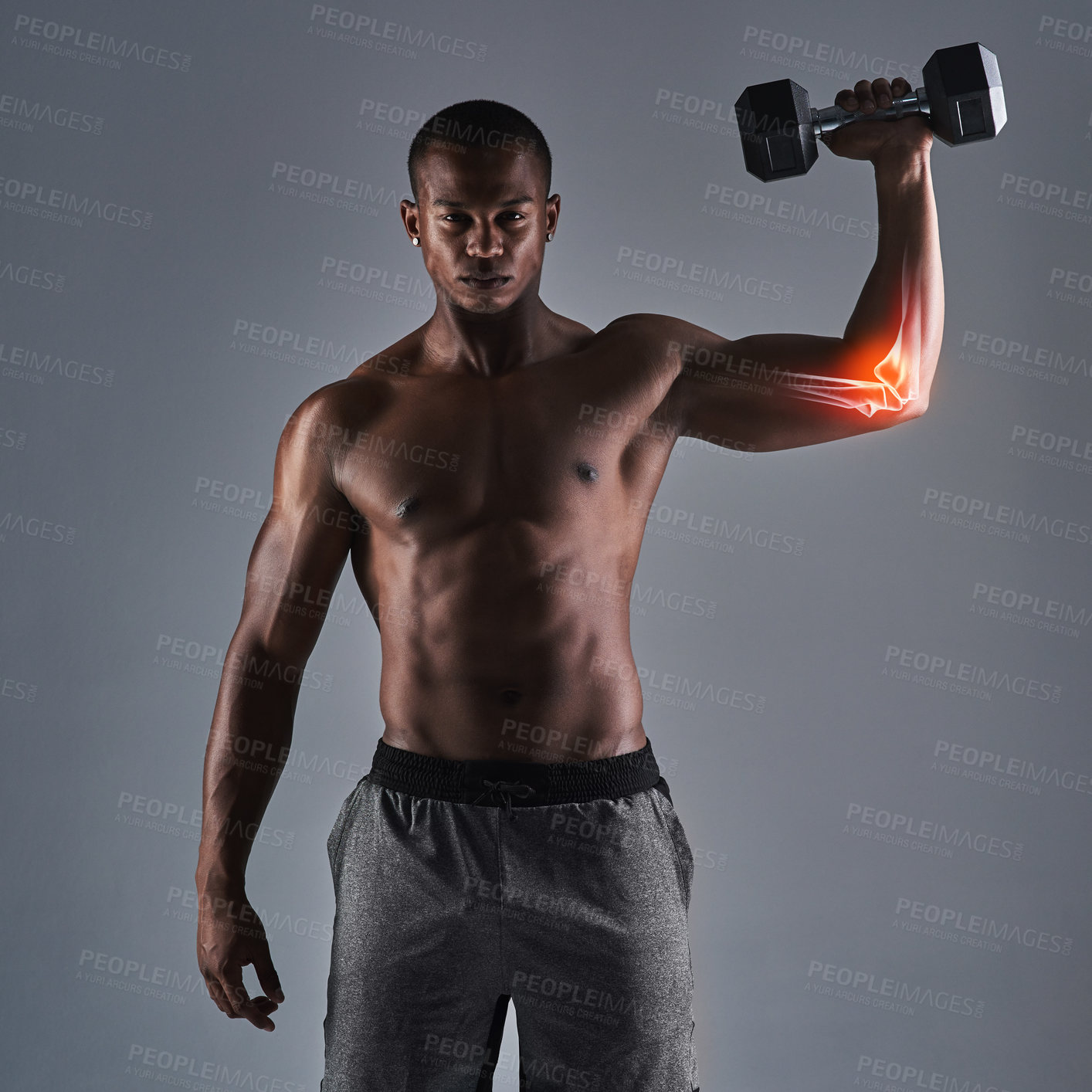 Buy stock photo Cropped portrait of an athletic young man working up with a dumbbell