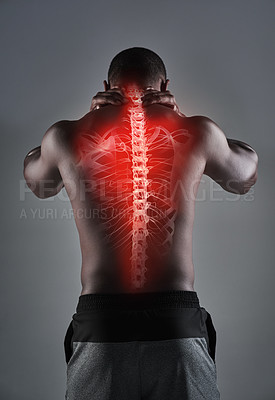 Buy stock photo Rearview shot of an athletic young man with his back injury highlighted