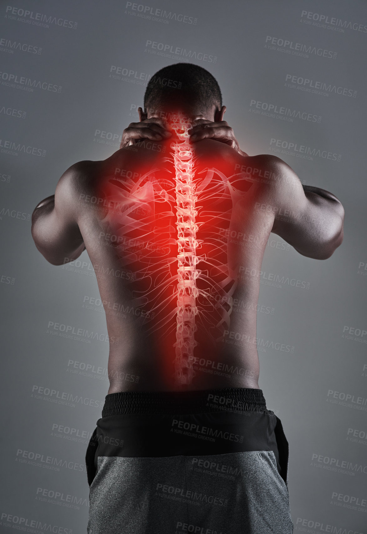 Buy stock photo Rearview shot of an athletic young man with his back injury highlighted