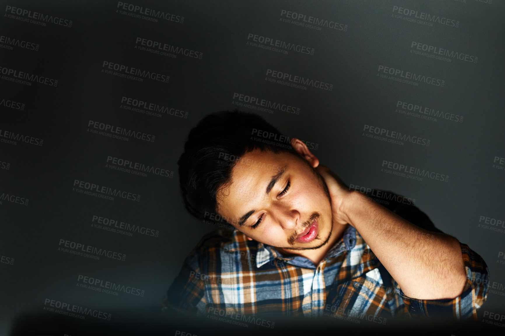 Buy stock photo Night, tired and business man with neck pain with stress, burnout or overwork at creative startup. Fatigue, injury and worker with joint problem, sore muscle or massage on deadline on wall background