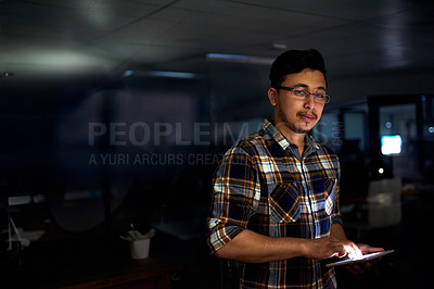 Buy stock photo Portrait of a male designer working on a digital tablet late in the office