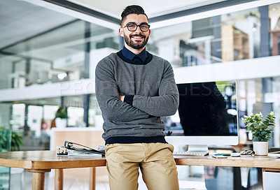 Buy stock photo Portrait of a confident young designer standing at his desk in an office