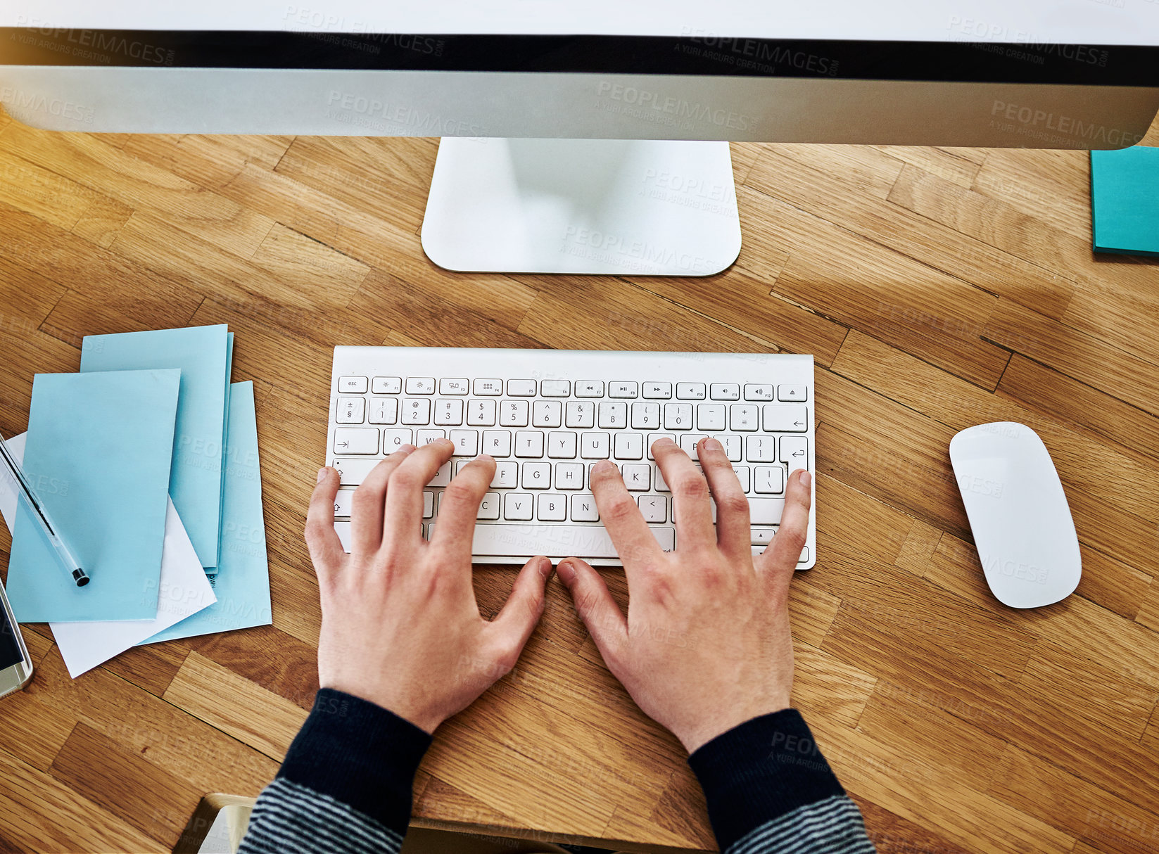 Buy stock photo High angle shot of an unidentifiable businessman working on a computer in an office