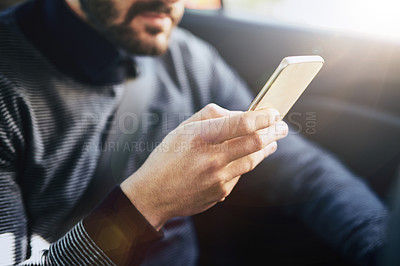 Buy stock photo Closeup shot of an unrecognisable man using a cellphone in a car