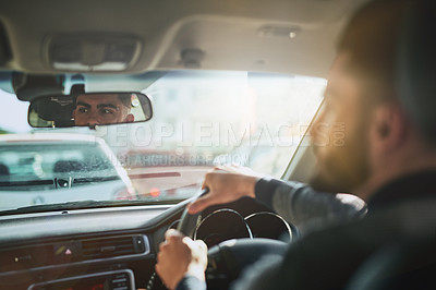 Buy stock photo Shot of a young man driving a car