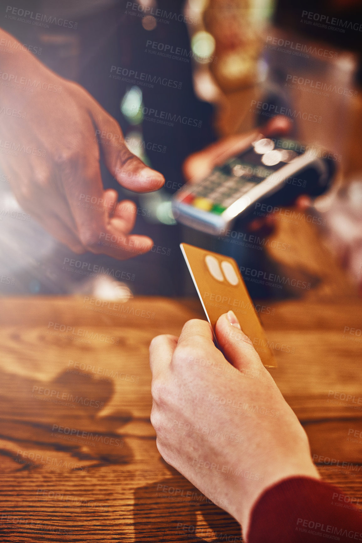 Buy stock photo Closeup shot of a woman paying using NFC technology in a cafe