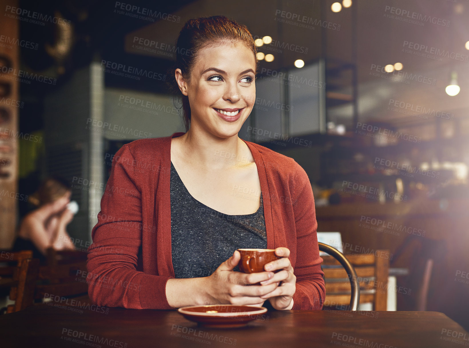 Buy stock photo Cropped shot of a young woman having a cup of coffee in a cafe