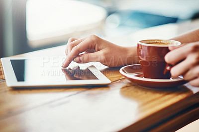 Buy stock photo Cropped shot of a woman using a digital tablet in a coffee shop