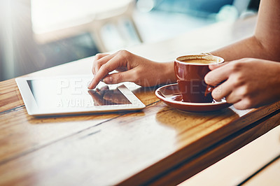 Buy stock photo Cropped shot of a woman using a digital tablet in a coffee shop