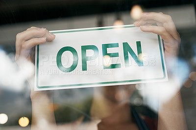 Buy stock photo Cropped shot of a woman hanging an open sign on the door of her store