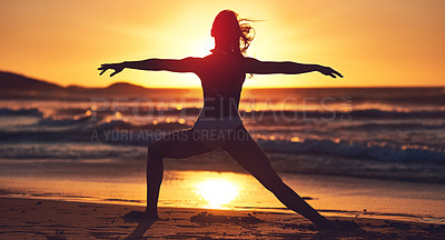 Buy stock photo Silhouette of young woman practising yoga on the beach