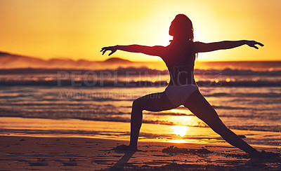 Buy stock photo Silhouette of young woman practising yoga on the beach