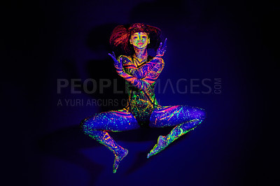 Buy stock photo Body paint, dance and portrait of a woman in neon lighting isolated on a dark background in a studio. Creative, glow and a dancing model with psychedelic art for creativity and fluorescent abstract