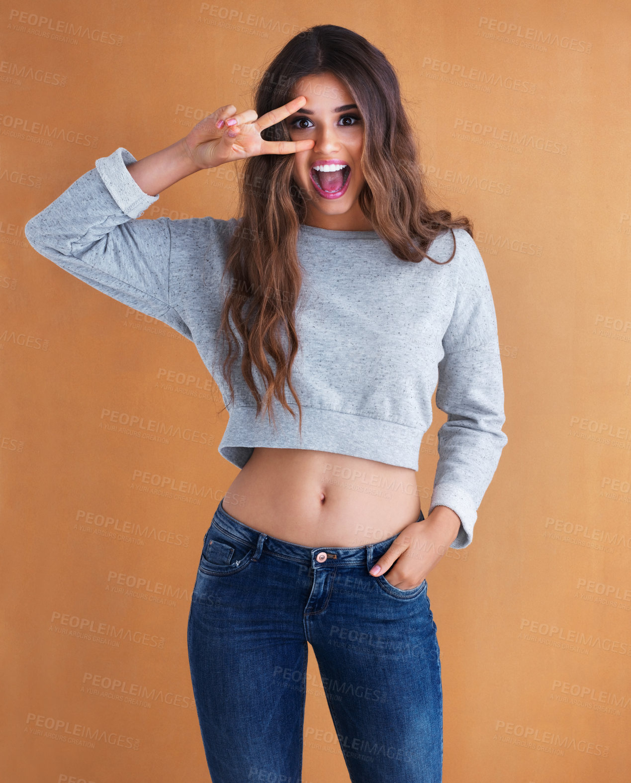 Buy stock photo Studio shot of an attractive young woman posing her her hand in her pocket