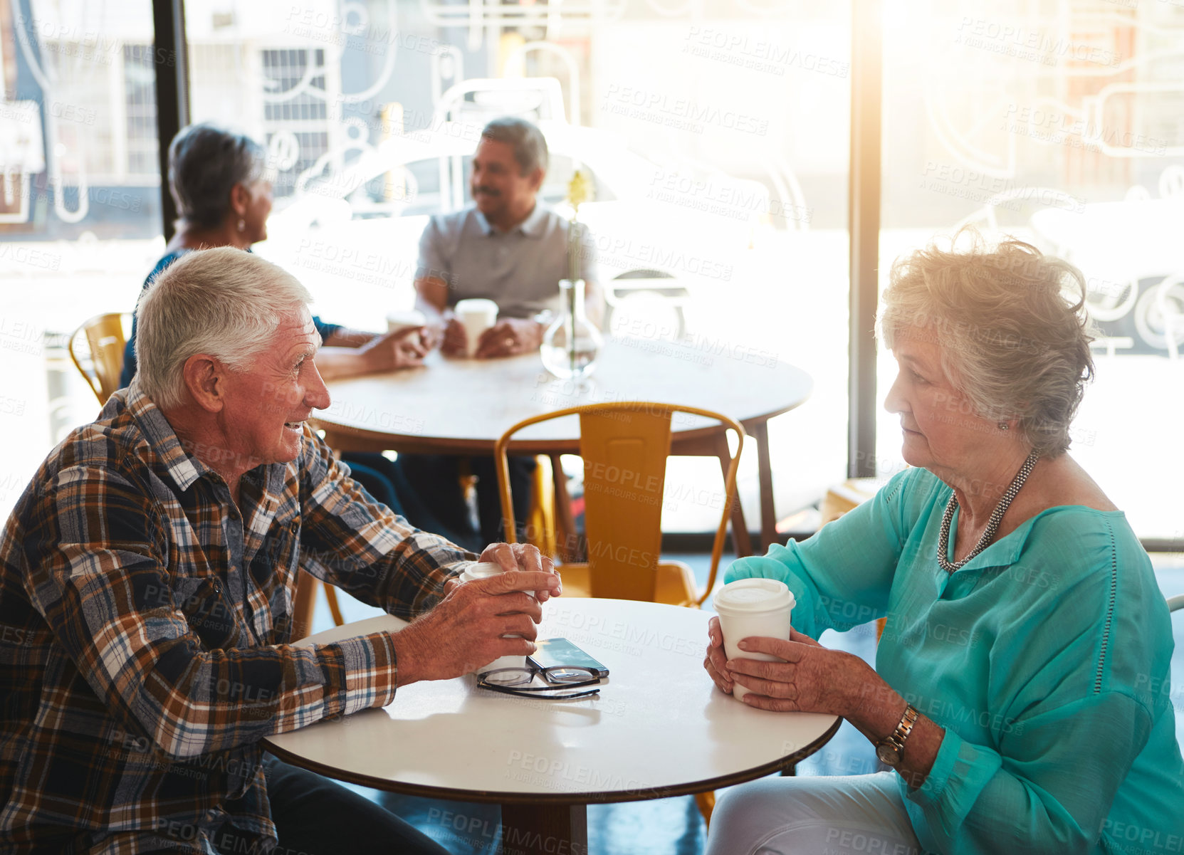 Buy stock photo Shot of a senior couple out on a date at a coffee shop