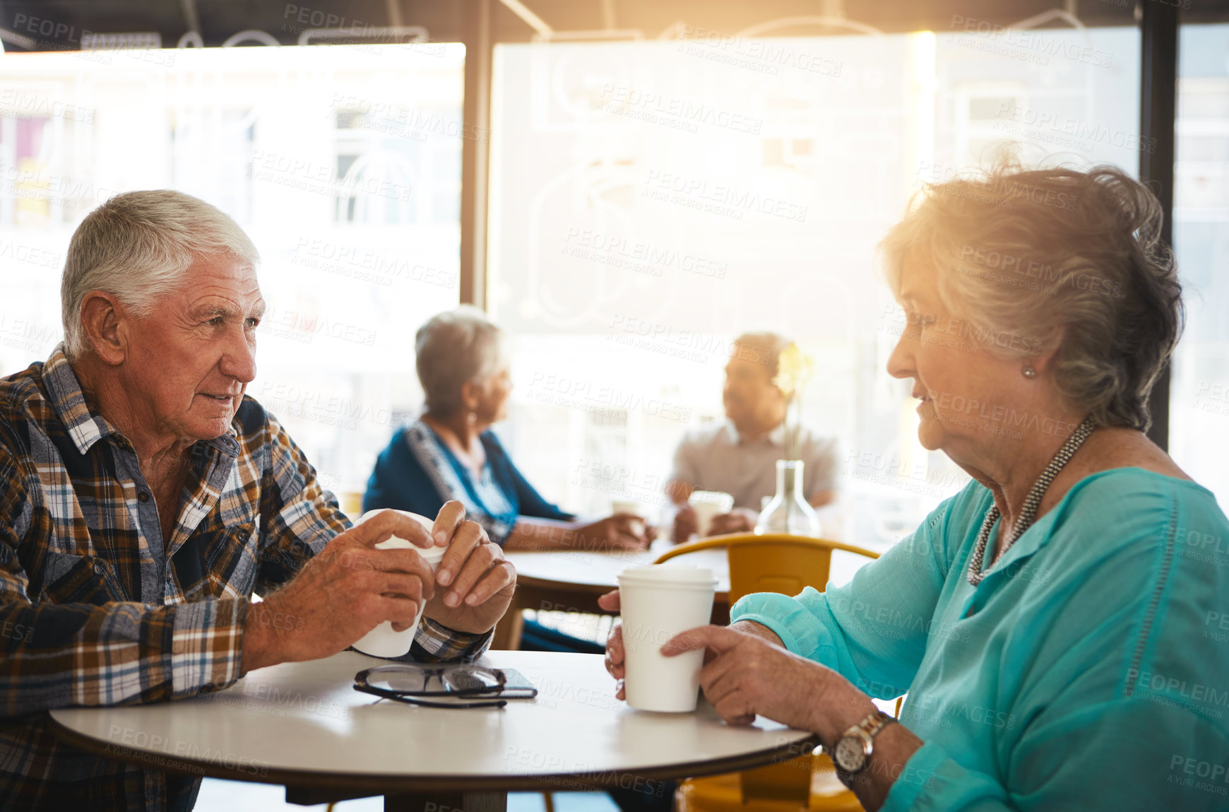 Buy stock photo Shot of a senior couple out on a date at a coffee shop