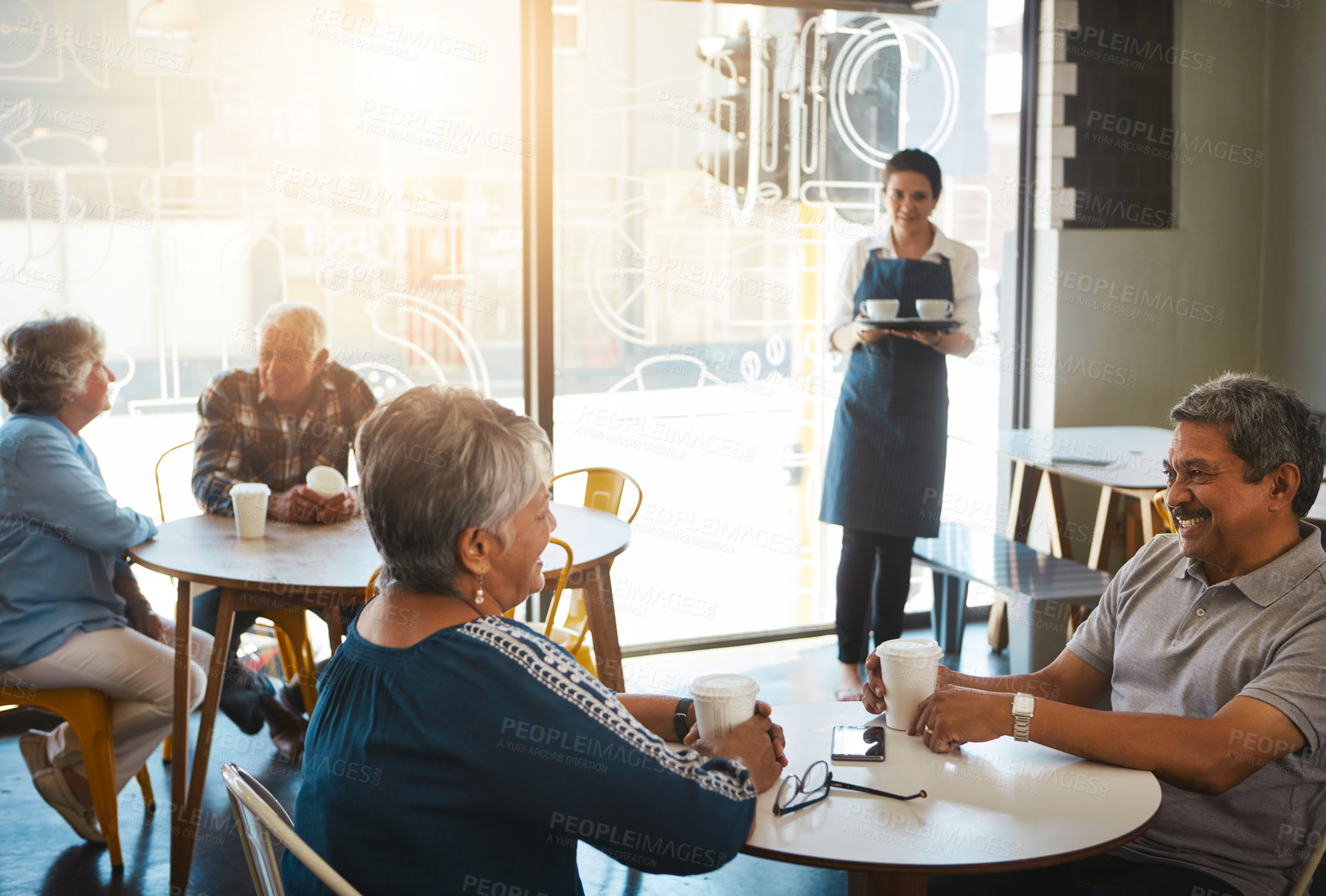 Buy stock photo Shot of a senior couple out on a date at a coffee shop