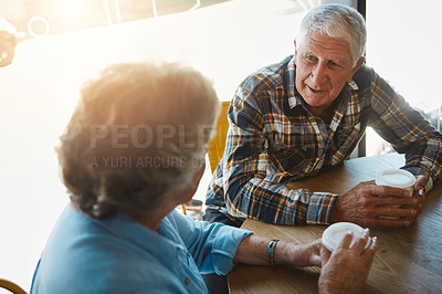 Buy stock photo Shot of a senior couple out on a date at a coffee shop