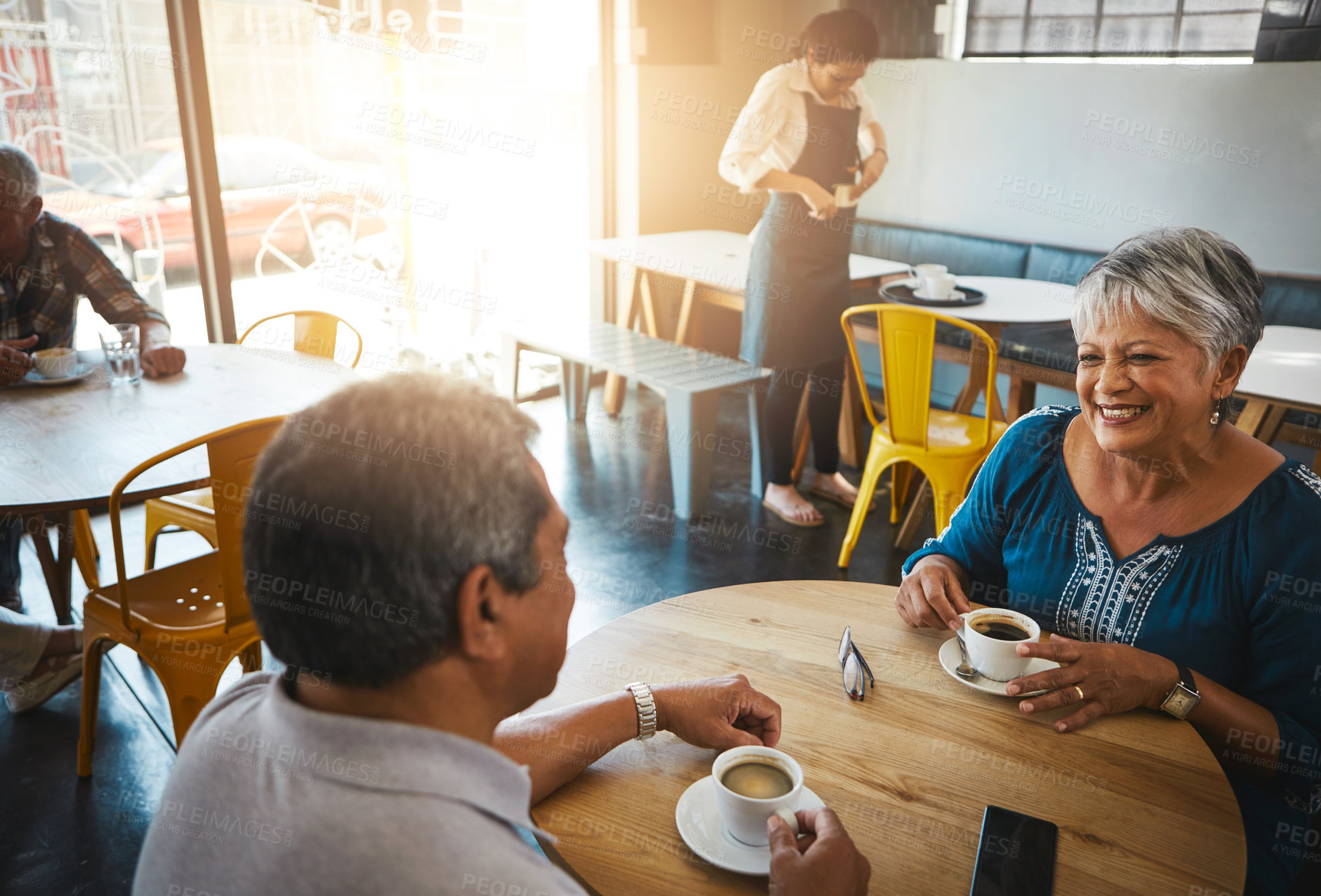 Buy stock photo Shot of a senior couple out on a date at a coffee shop