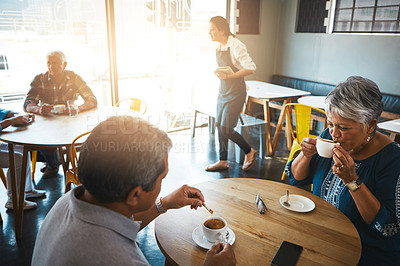 Buy stock photo Shot of a senior couple out on a date at a coffee shop