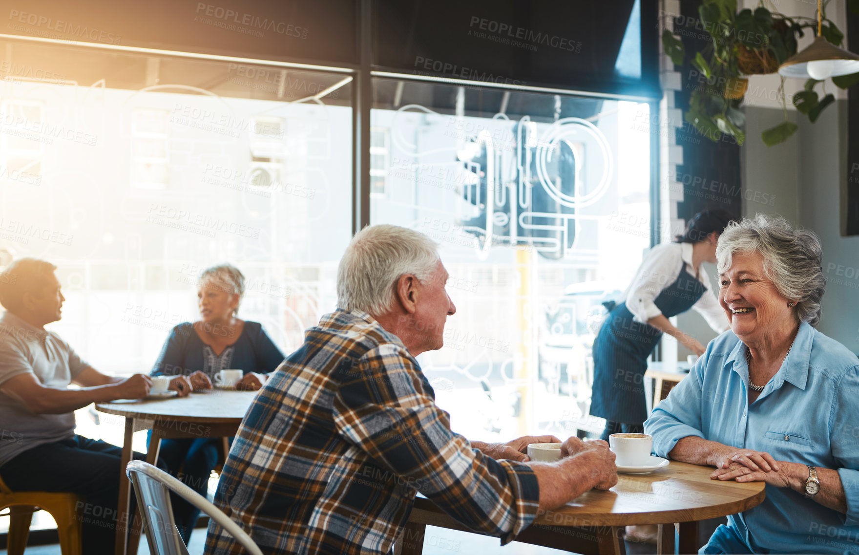 Buy stock photo Shot of a senior couple out on a date at a coffee shop