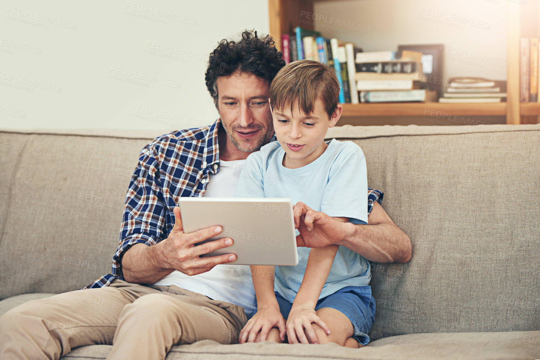 Buy stock photo Sofa, tablet and father with child in home for watching movies, cartoons and online entertainment. Family, love and happy dad with son on digital tech for internet, video call and relax on weekend