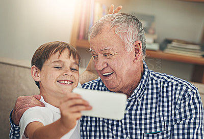 Buy stock photo Happy child, grandpa and bonding with selfie on sofa for photography, picture or memory together at home. Little boy or grandfather with smile for capture, moment or childhood in living room at house