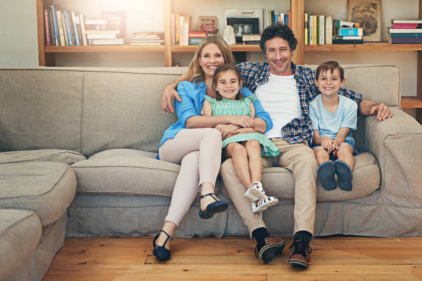 Buy stock photo Portrait of a happy family relaxing on the sofa together at home