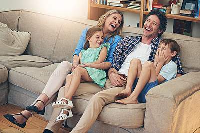 Buy stock photo Family, laughing and parents with children, funny and joke by dad, comedy and couch in house. Home, woman and man with kids, together and bonding for break in apartment, relax and mom with love