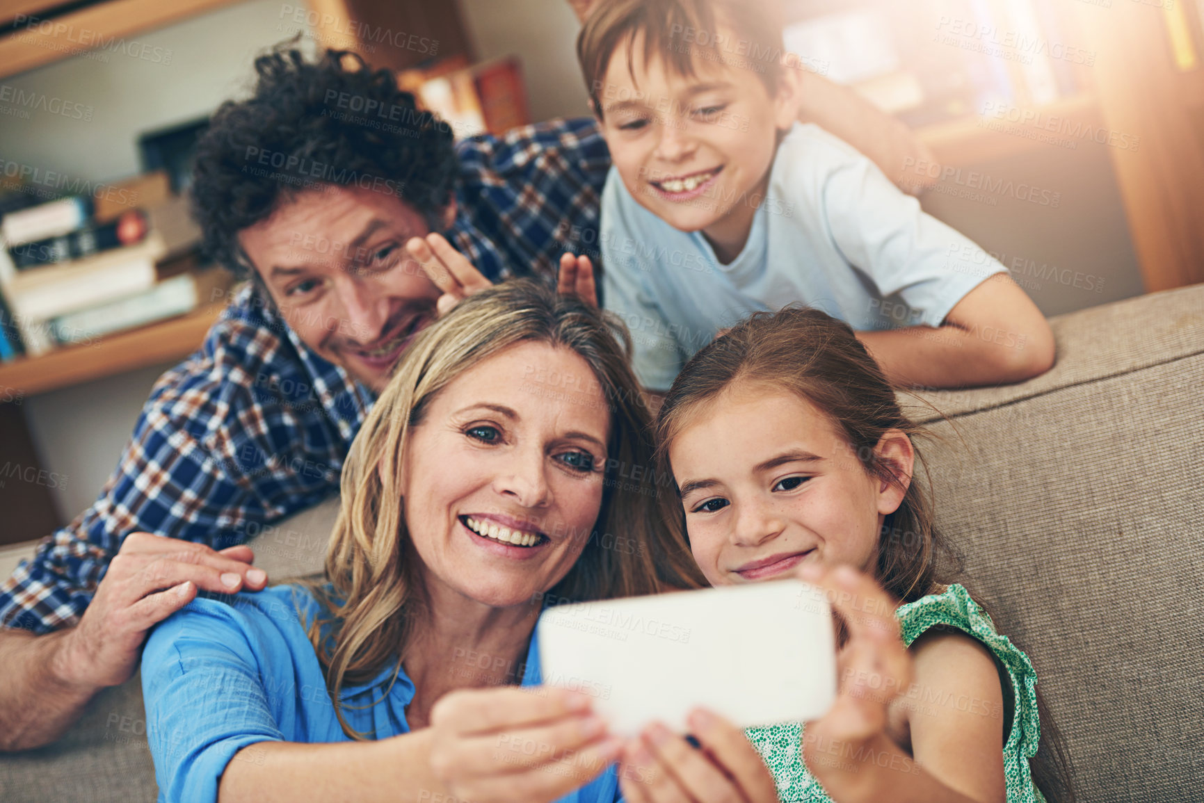Buy stock photo Happy family, relax and selfie with peace sign for memory, picture or bonding together on sofa at home. Mom, dad and young children with smile for photography, capture or moment on living room couch