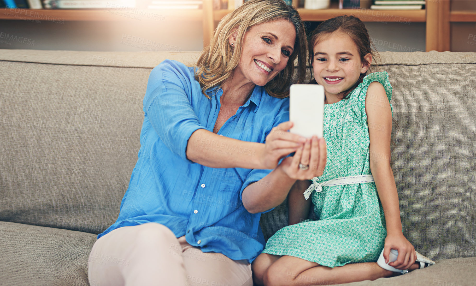 Buy stock photo Happy mother, daughter and relax with selfie on sofa for picture, memory or bonding together at home. Mom, child or kid with smile for photography, capture or moment on living room couch at house