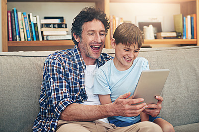 Buy stock photo Happy, tablet and father with child on sofa for watching movies, cartoons and online entertainment. Family, love and dad with son on digital tech for internet, video call and relax on weekend in home