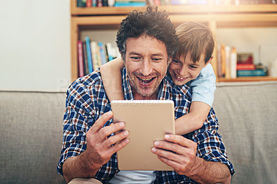 Buy stock photo Home, tablet and father with child on sofa for watching movies, cartoons and online entertainment. Family, love and happy dad with son on digital tech for internet, video call and relax on weekend