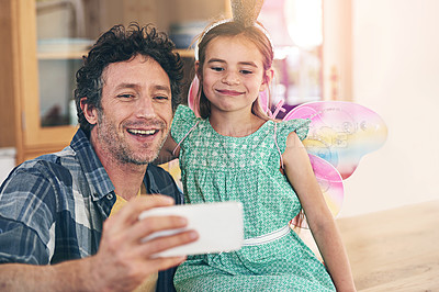 Buy stock photo Happy father, daughter and bonding with selfie on sofa for photography, picture or memory together at home. Little girl and dad with smile or costume for capture, moment or childhood in living room
