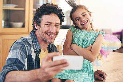 Buy stock photo Happy dad, kid and bonding with selfie for photography, picture or memory together at home. Father, child or little girl with smile or costume for capture, moment or childhood in living room at house